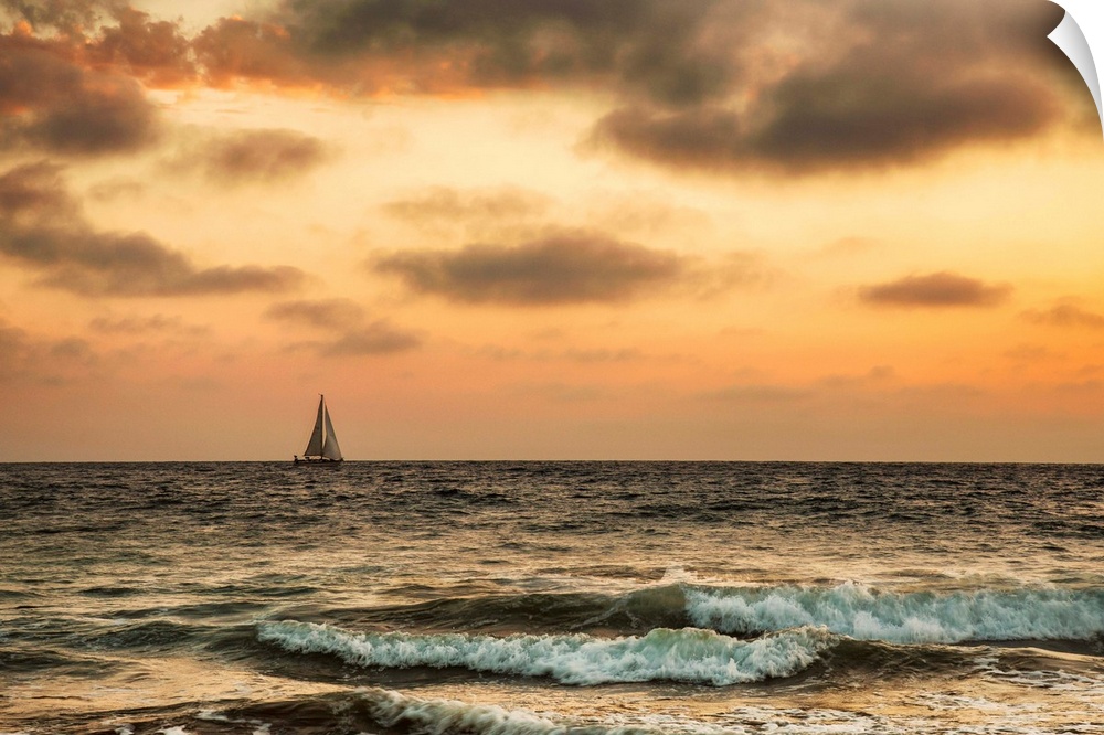 Sailboat off the coast of California at sunset.