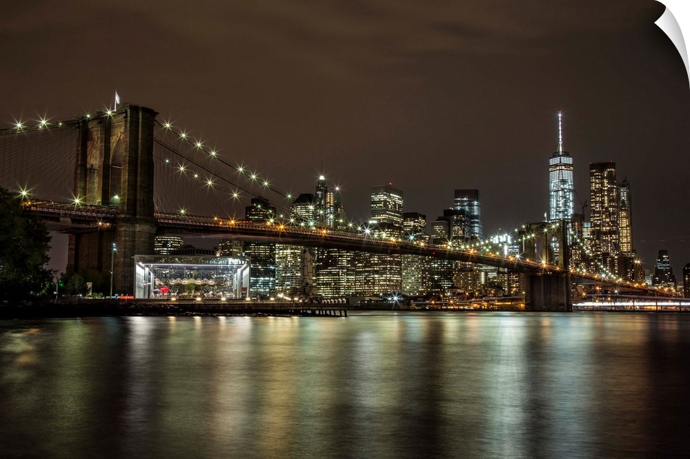 The Brooklyn Bridge and view of NYC after dark.