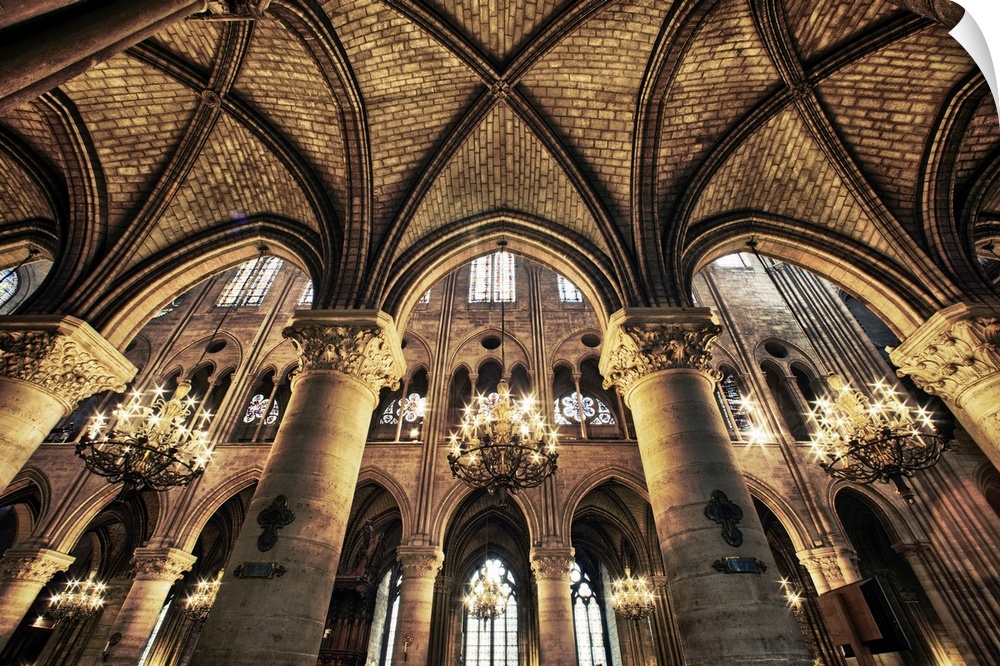 This photograph is taken inside of the Notre Dame Cathedral looking up at the beautiful arch ceiling.