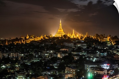 The Shwedagon Pagoda and nearby homes after dark in Yangon