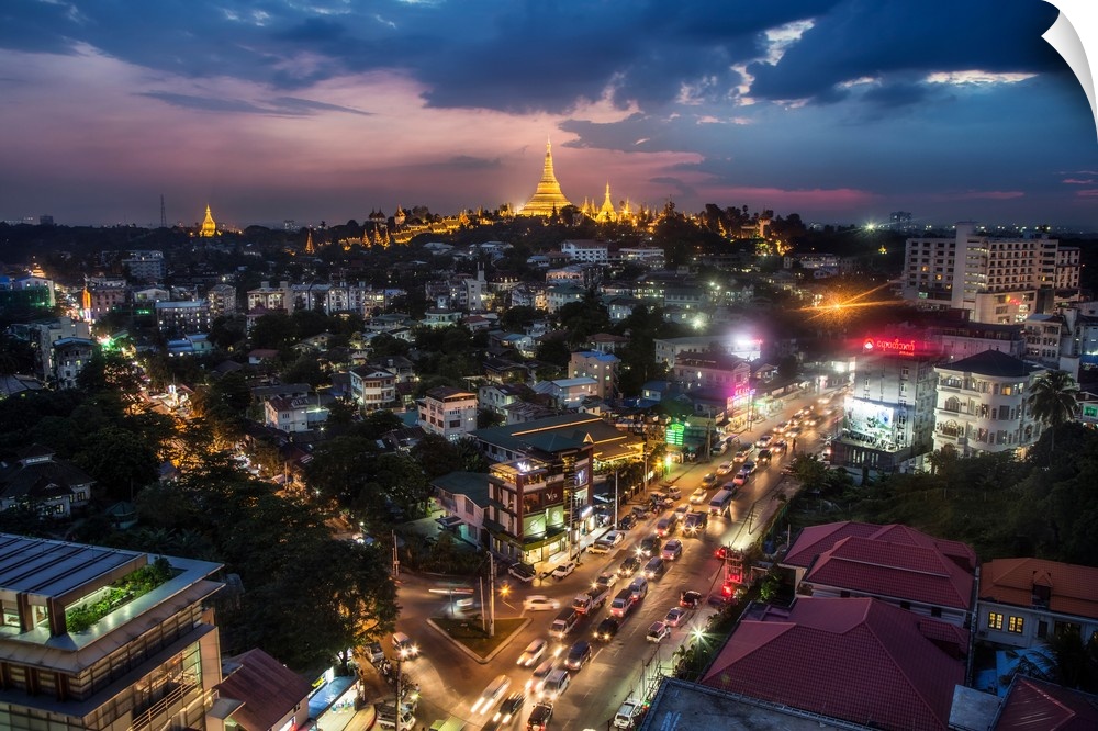 The Shwedagon Pagoda and nearby homes after dark in Yangon.
