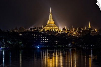 The Shwedagon Pagoda reflecting in the water after dark