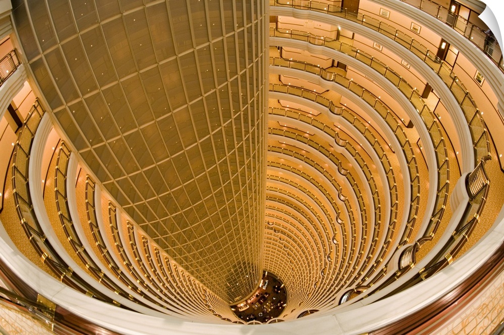 This large piece is a photograph that has been taken inside an extremely tall hotel and looking down through the center at...