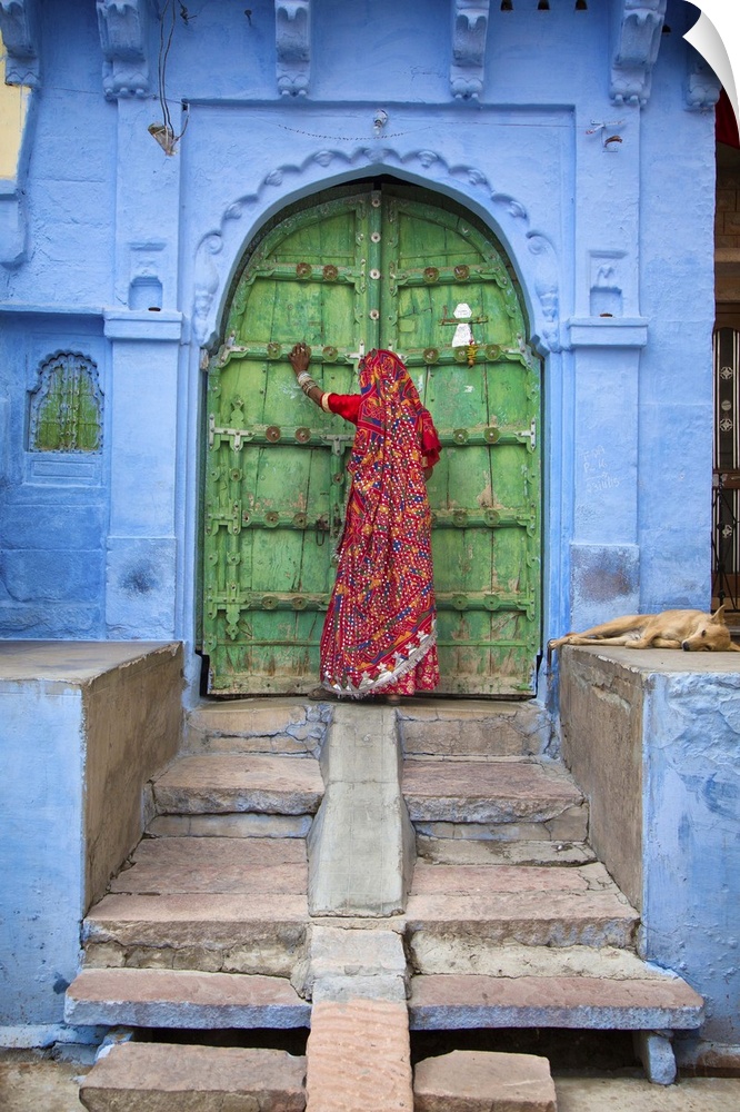Woman knocking on door in the Blue City of Jodphur, India.