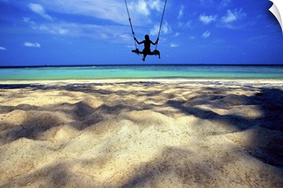 Woman on swing by the ocean, Koh Samui, Thailand