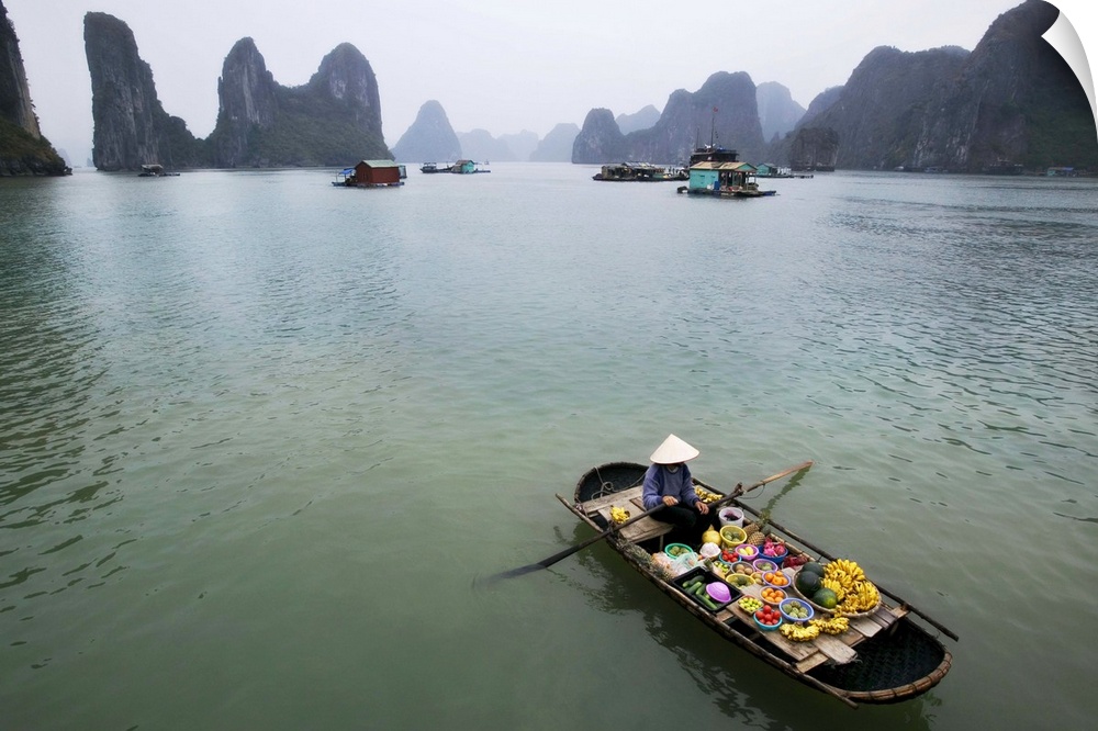 Woman selling fruit by her floating village, Halong Bay, Vietnam