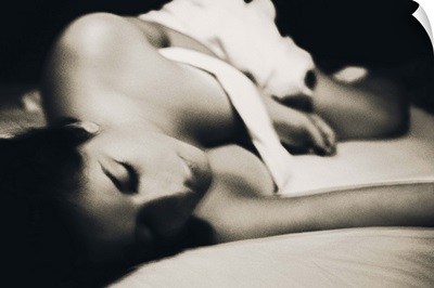 Woman under the sheets in bed, black and white photograph