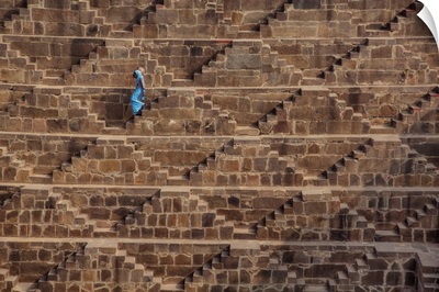 Woman with blue Sari walking in the Chand Baori Step Well