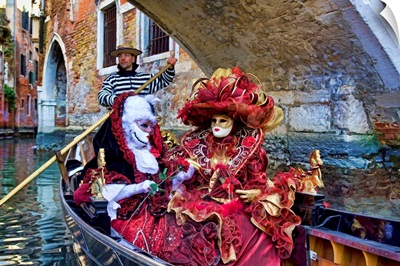 Women in Masquerade outfits on a gondola at Carnival in Venice,
