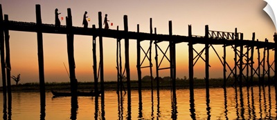 Women with lanterns walking across the Ubein Bridge in Burma