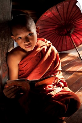Young monk boy reading in his monastery, Yangon, Burma