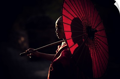 Young monk with parasol in Bagan, Myanmar