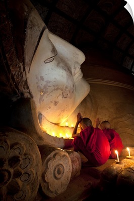 Young monks praying with Buddha, Bagan, Burma