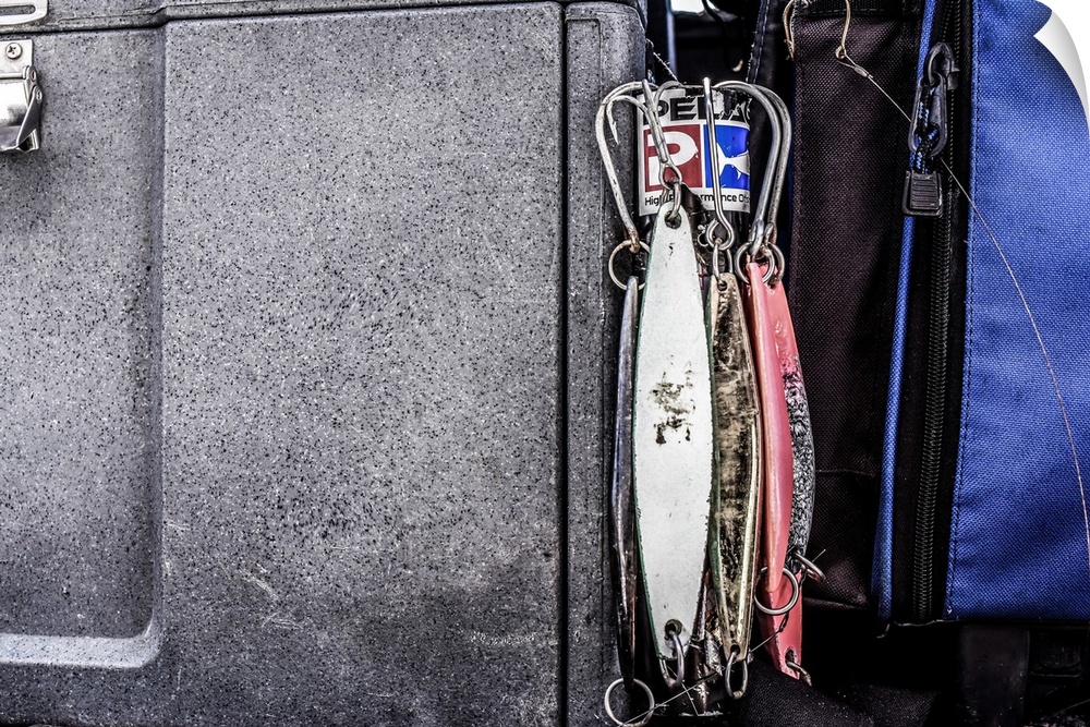 A set of fishing lures hang on a box waiting to be fished. Location: Excel Sportboat.