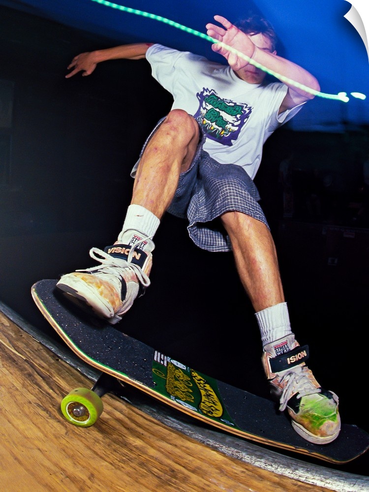 Danny Sargent doing a kick flip on his skateboard at night in San Francisco, 1989.