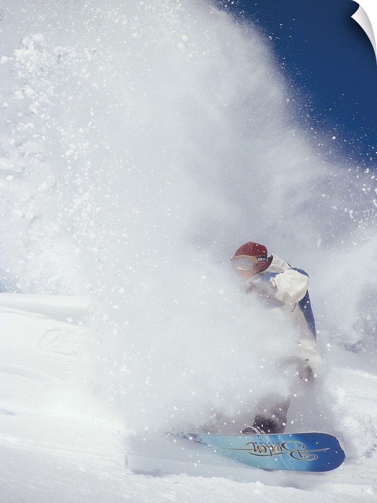 Ian Spiro almost hidden in a cloud of snow, snowboarding at North Cascade Heli Skiing, Mazama, Washington.