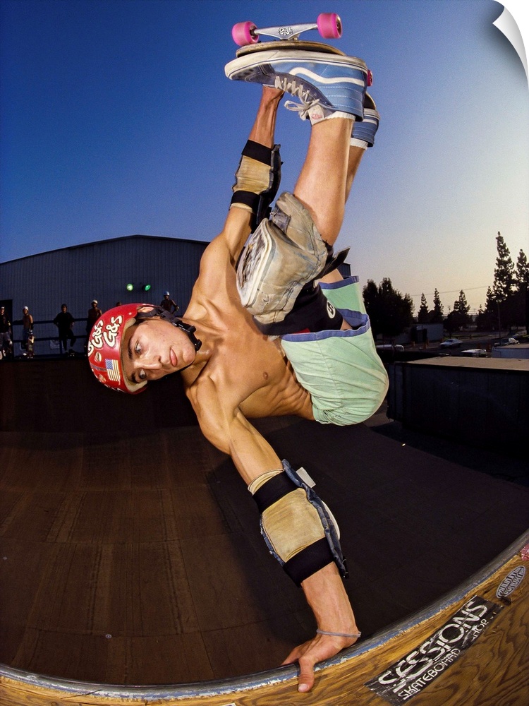 Skateboarder Remy Stratton performing a trick and grabbing a rail in Orange County, California, 1989.
