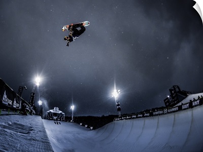 Snowboarder Ben Ferguson with a huge air in the halfpipe in Aspen, CO 2016
