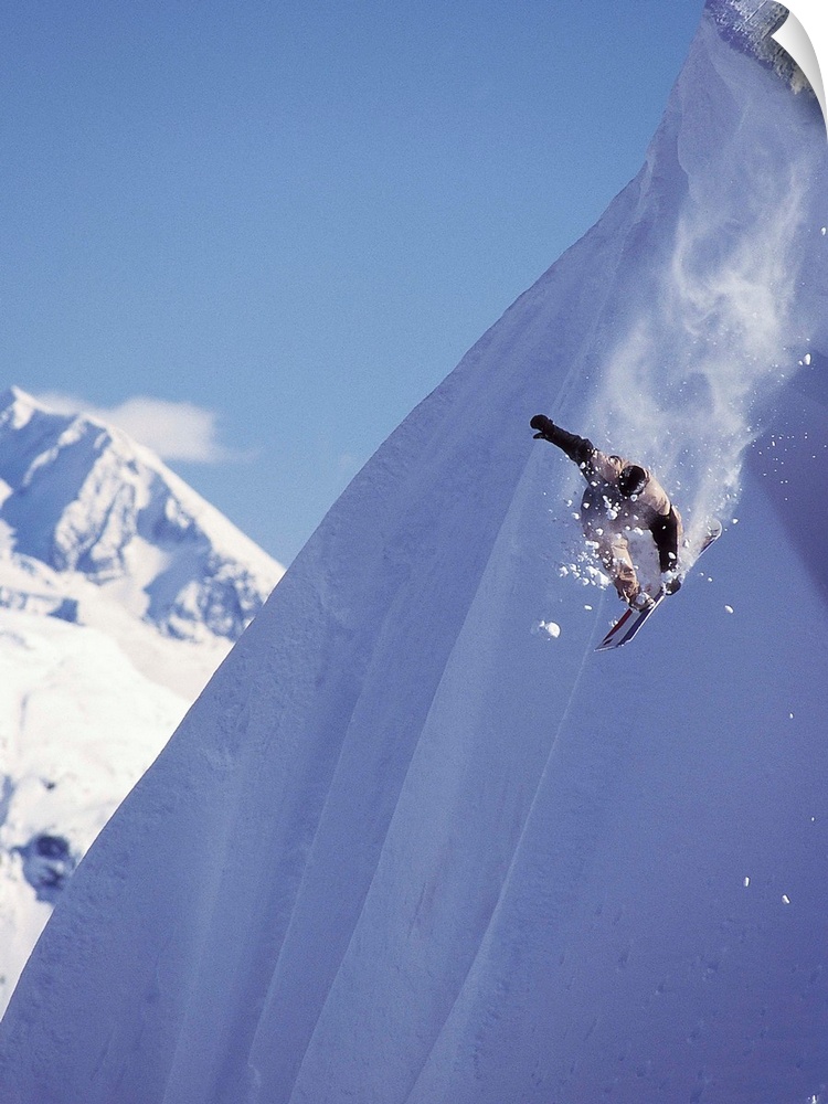 Travis Parker snowboarding down a steep mountainside at Whistler, British Columbia, Canada.