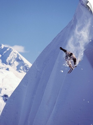 Travis Parker snowboarding down the mountainside at Whistler, Canada