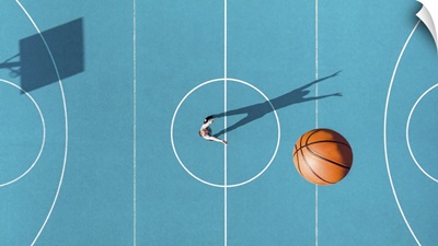 Basketball Player With Long Shadows On Basketball Court