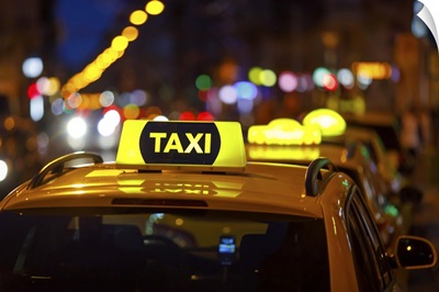 Taxi And Blurred City Lights At Night