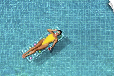 Woman In A Yellow Bikini, Swims In The Pool Of A Luxury Hotel, Summer Vacation