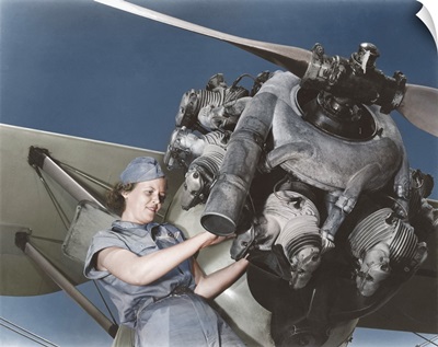 A 20 year old woman and expert aviation mechanic rebuilding an airplane engine.