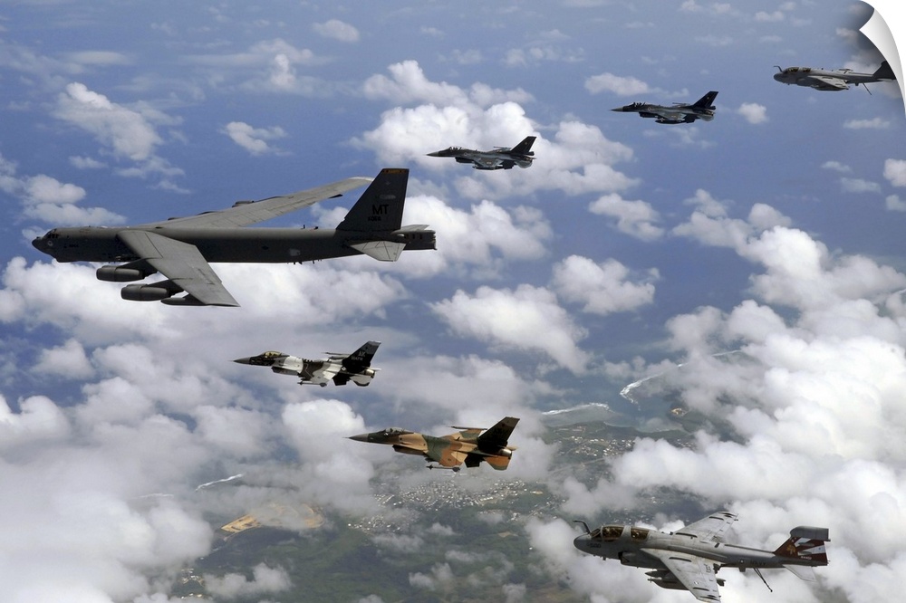 A B-52 Stratofortress leads a formation of aircraft over Guam.