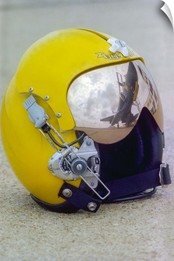 A Blue Angels pilot helmet with aircraft reflection in visor.