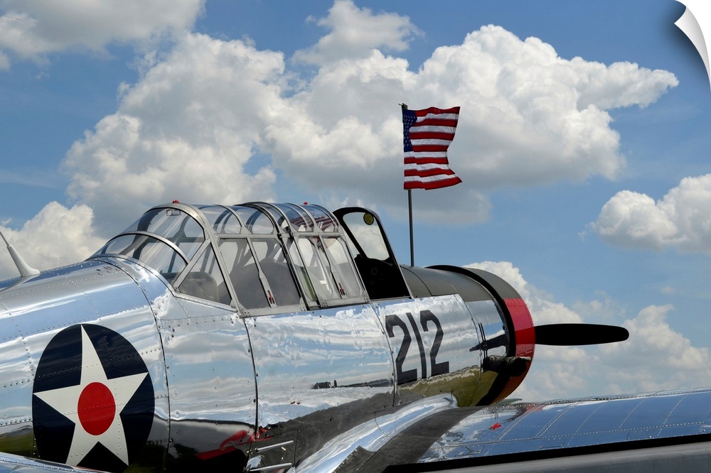 A BT-13 Valiant trainer aircraft with American Flag.