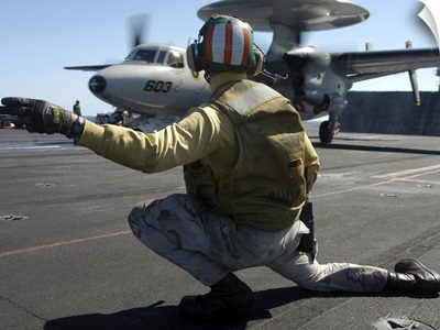A Catapult Shooter Signals The Launch Of An E-2C Hawkeye