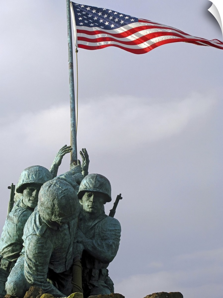 Up-close photograph of monument of soldiers lifting the American flag.