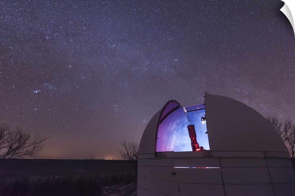 A domed observatory is open for business as a refractor telescope surveys the heavens, Crowell, Texas.
