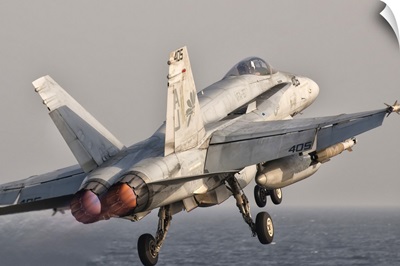 A F/A-18C Hornet taking off from USS George H.W. Bush