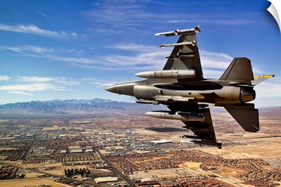 A fighter jet breaks right on a final approach over northern Las Vegas, Nevada