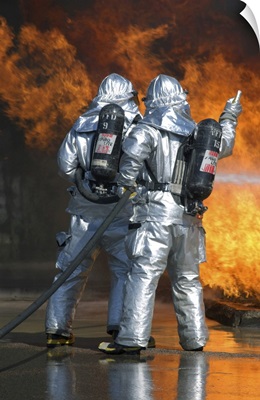 A Firefighter Fights A Fire During A Readiness Training Exercise