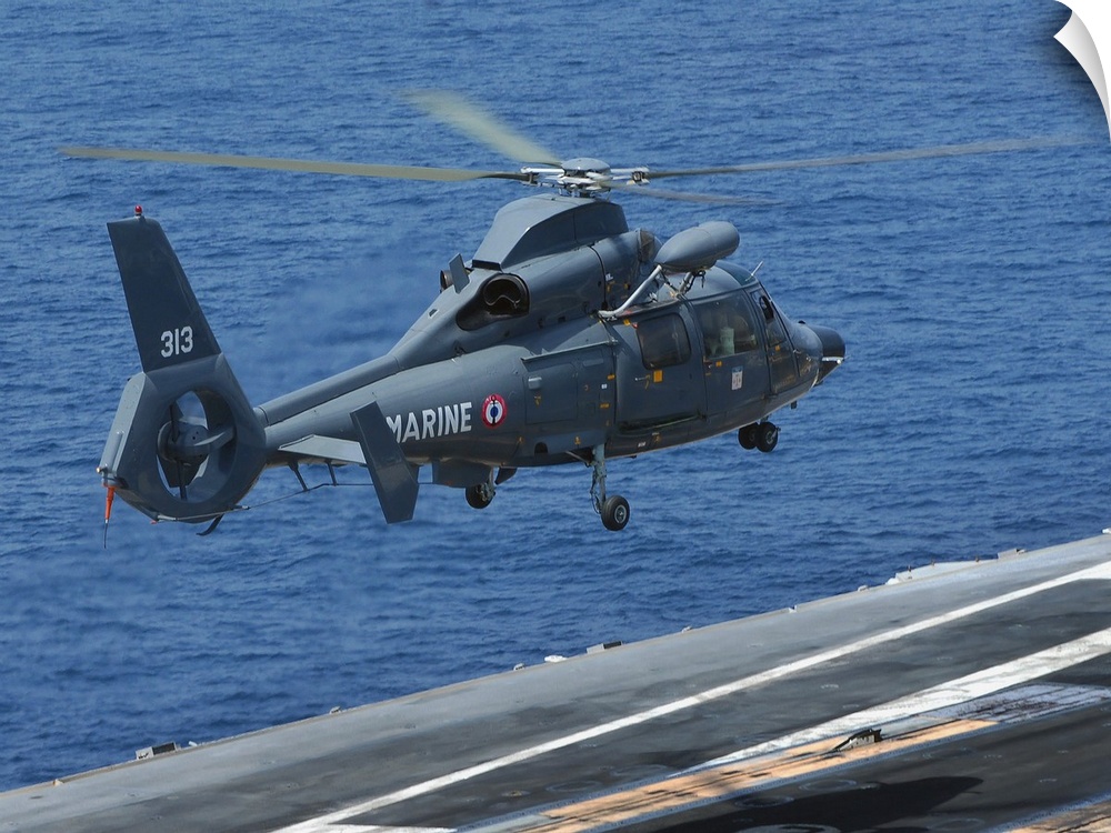 A French Dolphin 35F helicopter takes off from the flight deck of USS John C. Stennis.