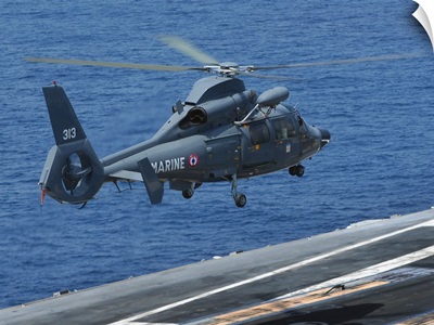 A French Dolphin 35F helicopter takes off from the flight deck of USS John C. Stennis