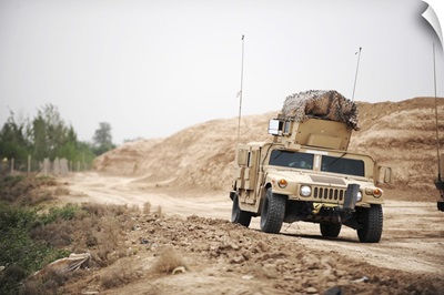A Humvee conducts security during a patrol in the Iraqi village of Bakr