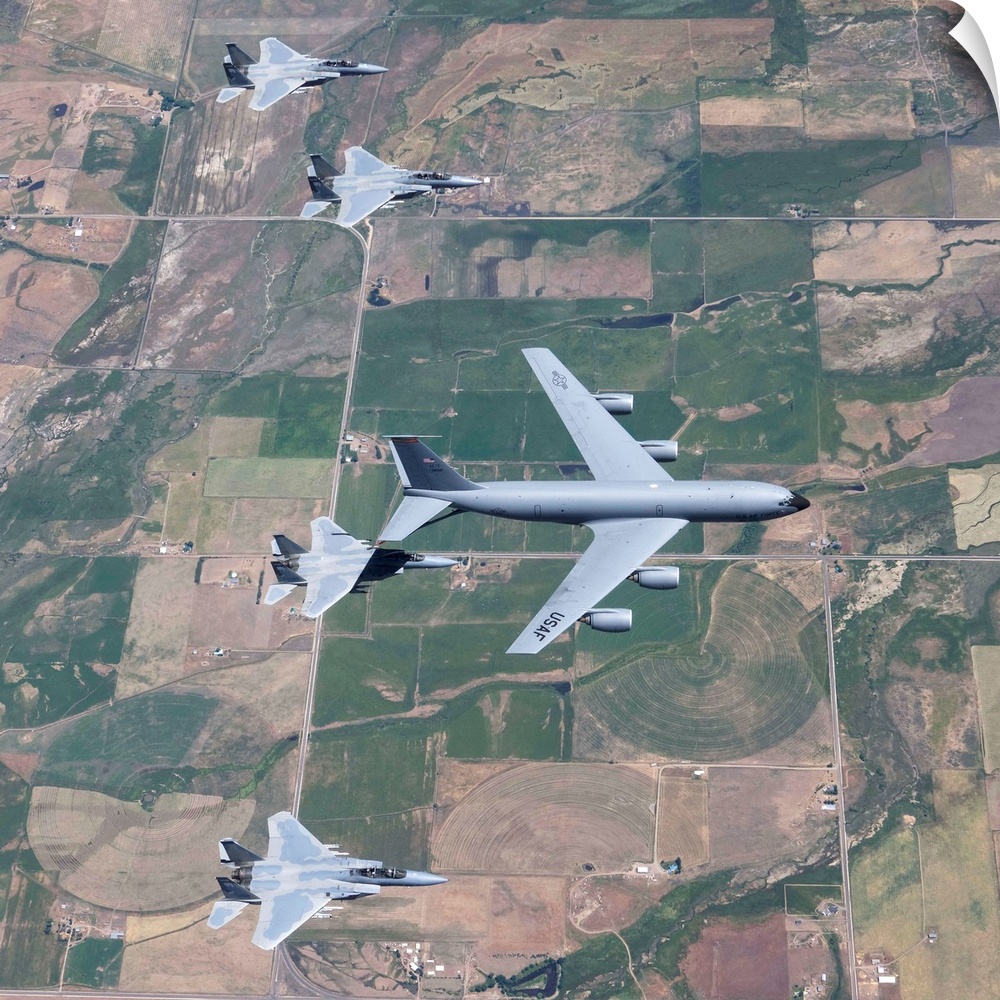 A KC-135R Stratotanker refuels four F-15 Eagles during air-to-air refueling training over central Oregon.