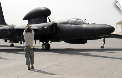 A Maintenance Airman Guides A Pilot In A U-2 Dragon Lady Aircraft To A Parking Space