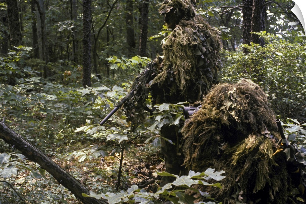 A Marine sniper team wearing camouflage ghillie suits on a training patrol at the Marine Corps Development and Education C...