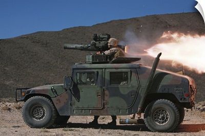 A missileman firing a BGM-71 TOW missile atop a humvee
