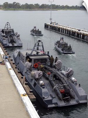 A MKV Special Operations Craft tied pierside manned and loaded