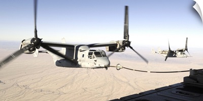 A MV22 Osprey refuels midflight while another waits its turn