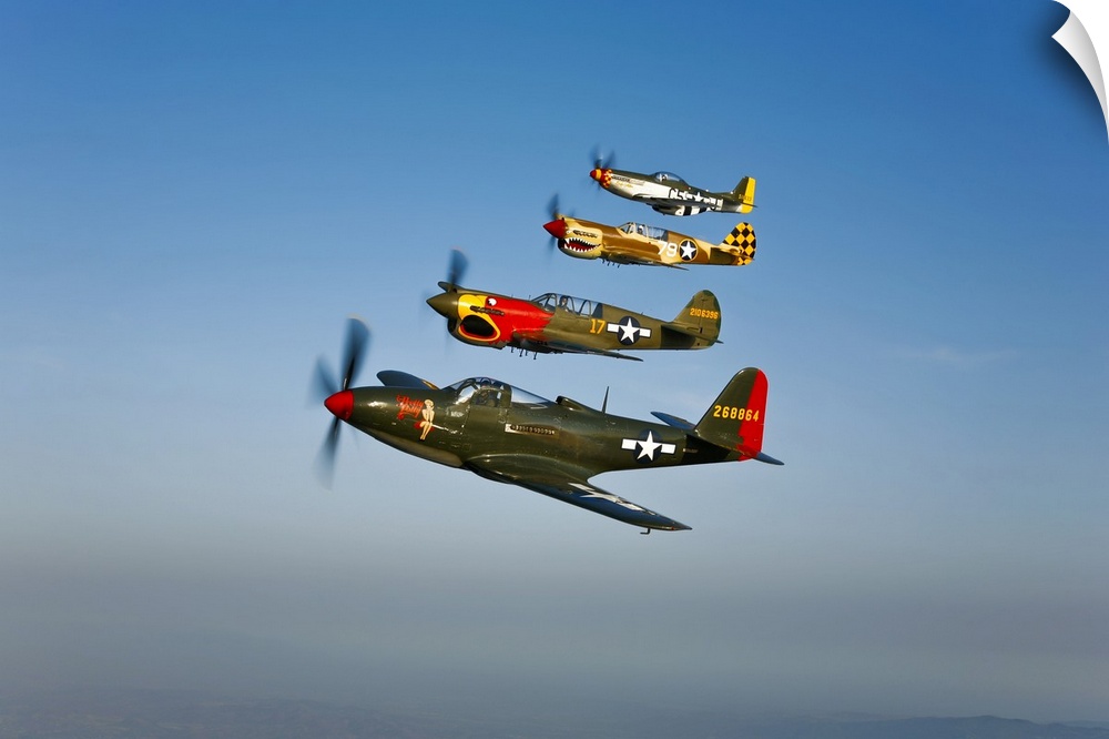 A Bell P-63 Kingcobra, two Curtiss P-40N Warhawk, and a North American P-51D Mustang in flight near Chino, California.