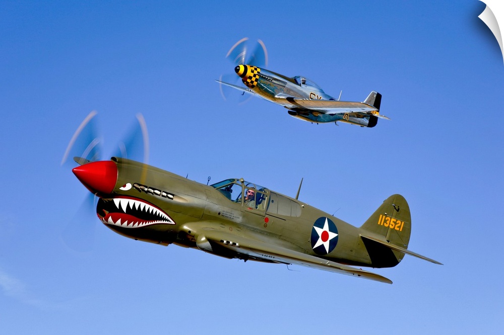 Photograph taken of classic military aircrafts as they fly in sync across a clear blue sky.