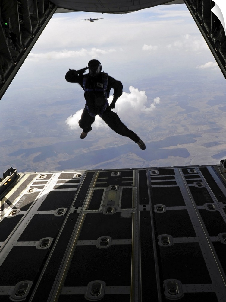 March 18, 2011 - A paratrooper salutes as he exits a C-130J Super Hercules during a combined high-altitude, low-open jump,...