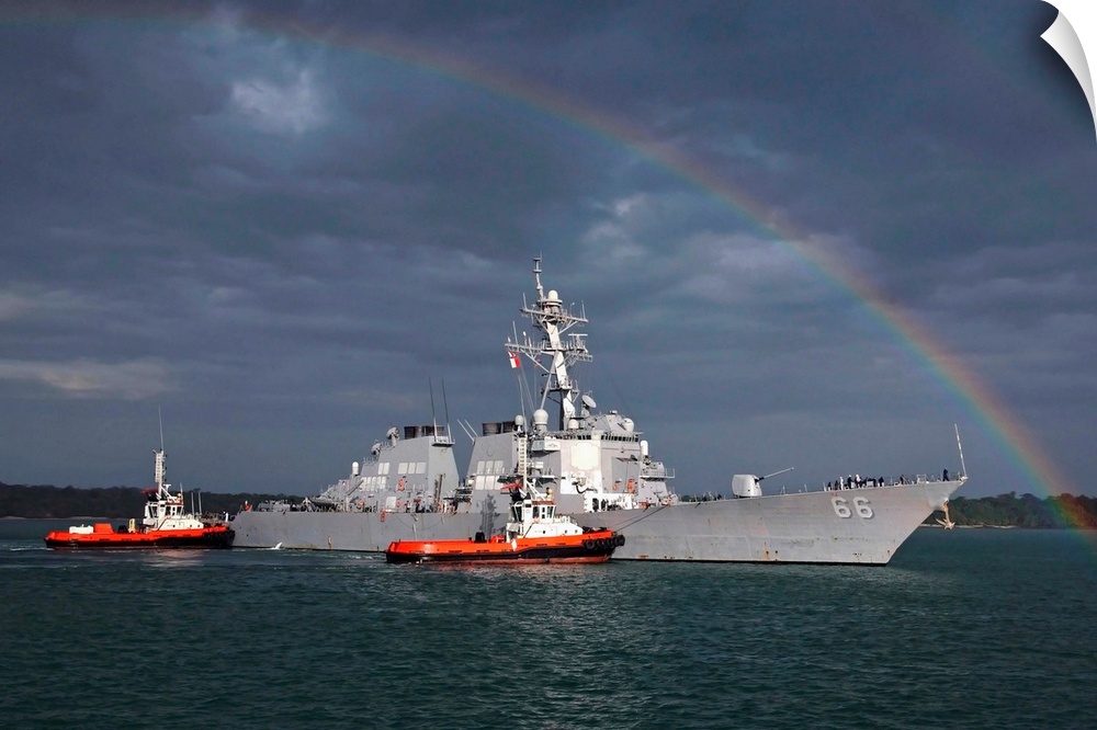 A rainbow arches over the guided missile destroyer USS Gonzalez